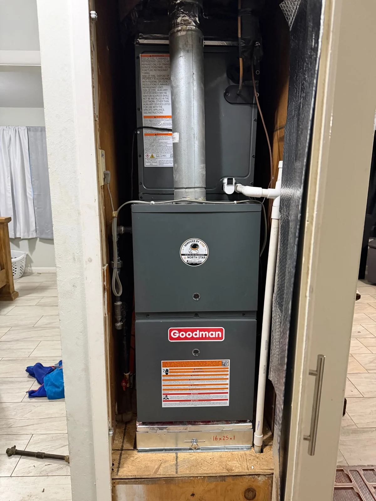 Finished HVAC installation photo showing the new Goodman furnace installed in the closet