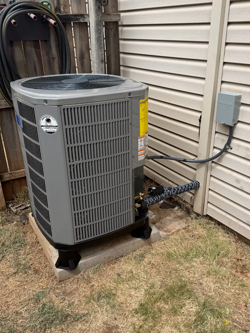 New outdoor air conditioning condenser with North Star Comfort service branding